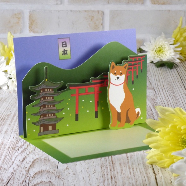Japanese greetings card on table top showing pop up scene inside