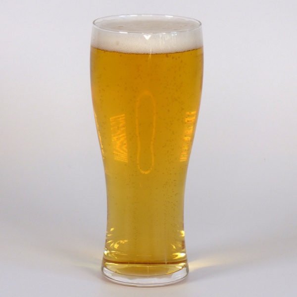 Slim Japanese beer glass filled with light beer