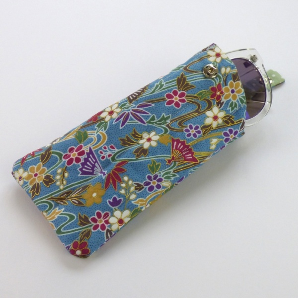 Sunglasses case in light blue traditional Japanese fans and water pattern fabric with sunglasses inserted