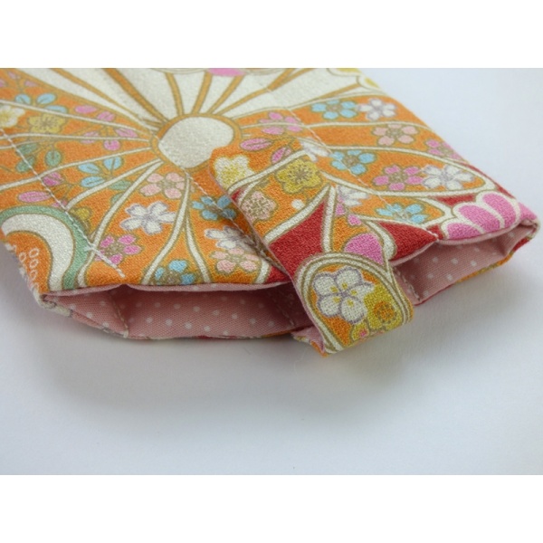 Sunglasses case in red traditional Japanese floral fabric close up of fastening