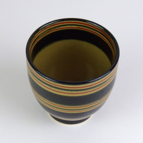 Black Japanese tea cup with red stripe pattern top view