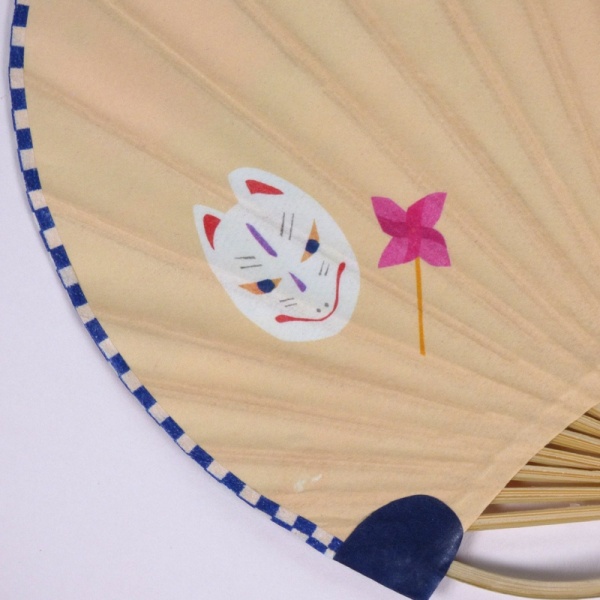 Close up of reverse side of Japanese fan showing kitsune fox mask graphic