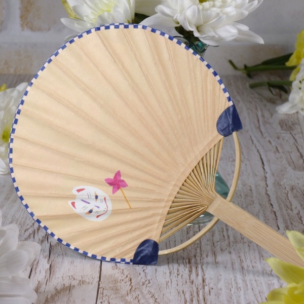 Reverse side of Japanese fan with masks design in summery table setting