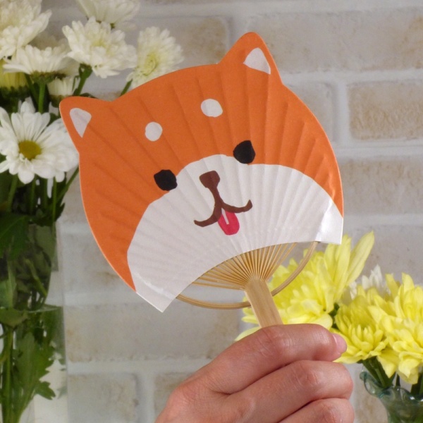 Cute shiba inu dog design fan held in hand