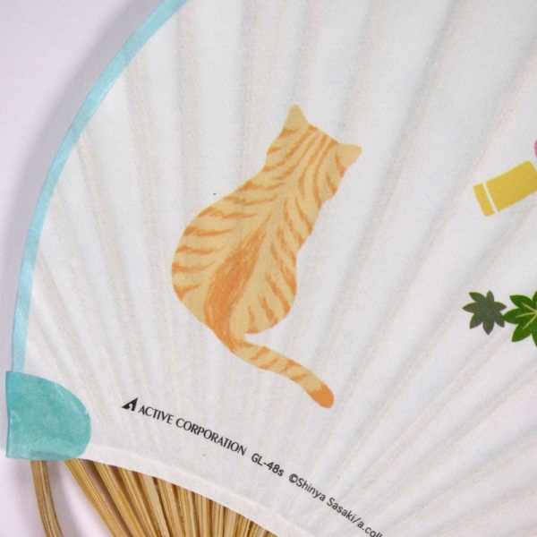 Close up of reverse side of Japanese fan showing cat illustration