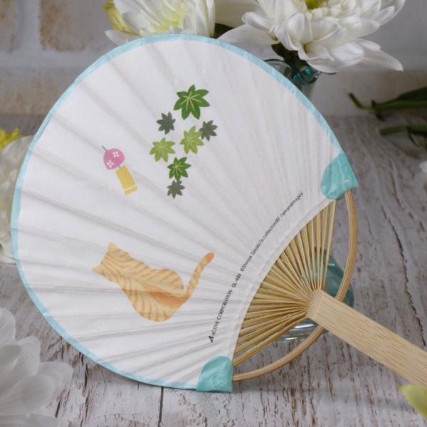 Reverse side of Japanese uchiwa round fan in summery table setting