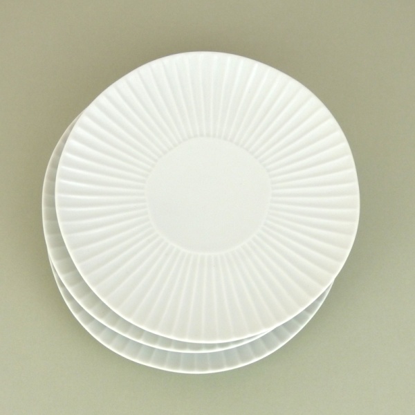 Matte white daisy design Japanese plates in a stack