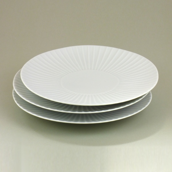 Matte white daisy design Japanese plates in a stack