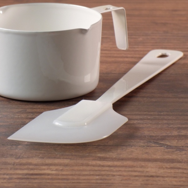 White enamel and silicone spatula with white enamel measuring cup