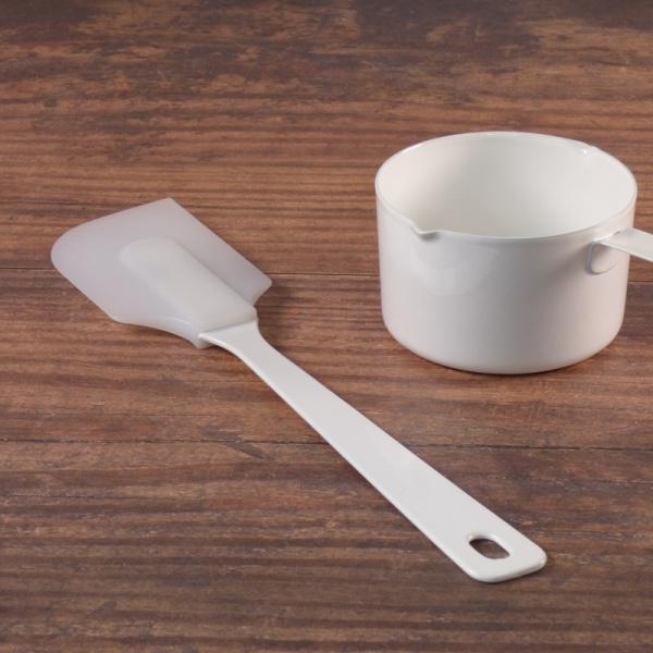 White enamel and silicone spatula with white enamel measuring cup