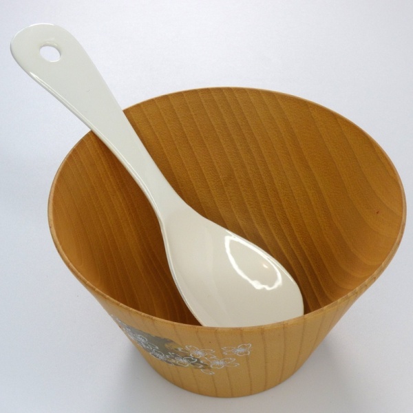 Japanese white enamel soup spoon in wooden soup bowl