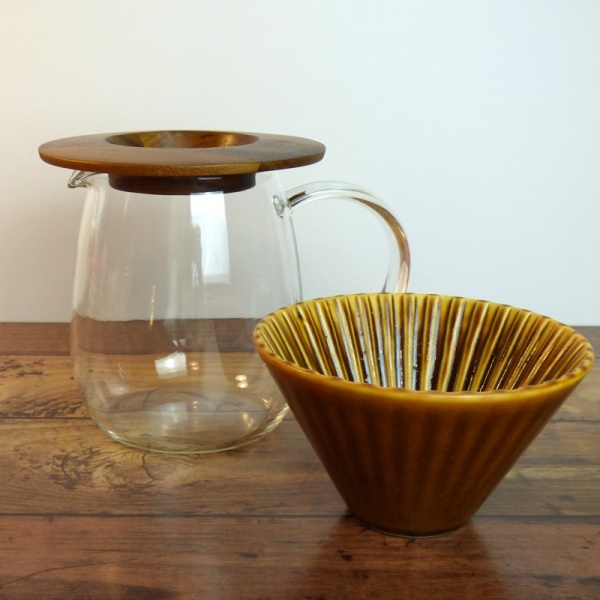 Clear glass coffee jug, caramel-coloured ceramic filter cone and wooden holder
