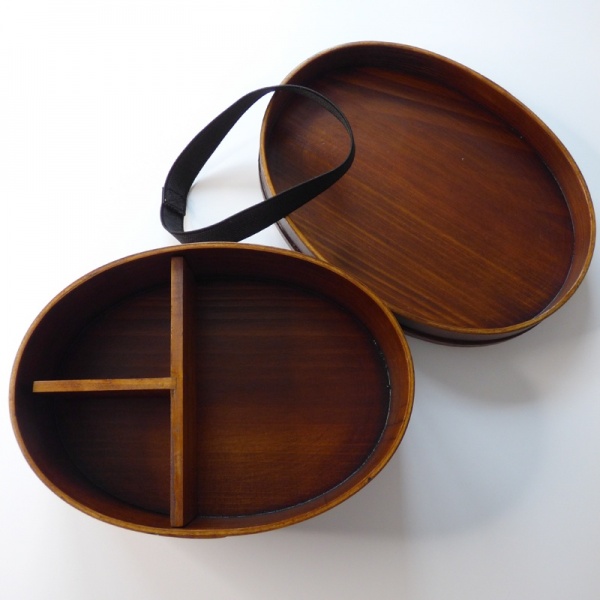 Interior of dark wood bento box with lid and fastening band