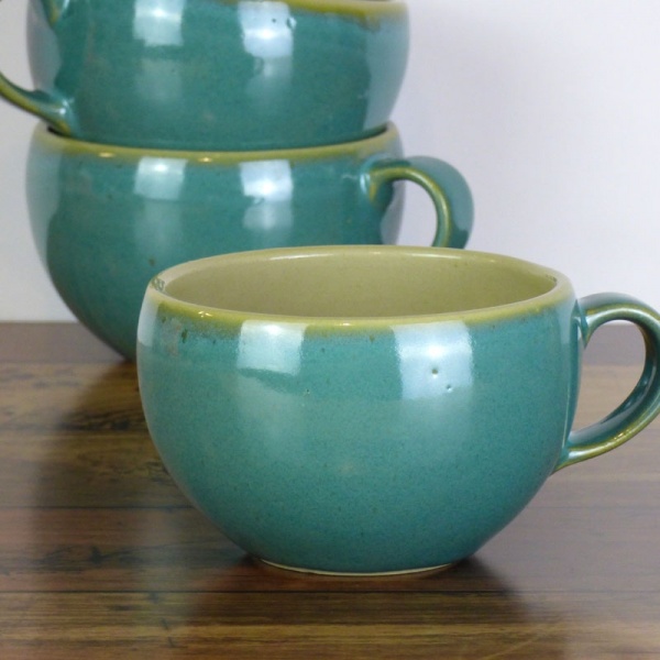 Blue ceramic cups on kitchen work surface