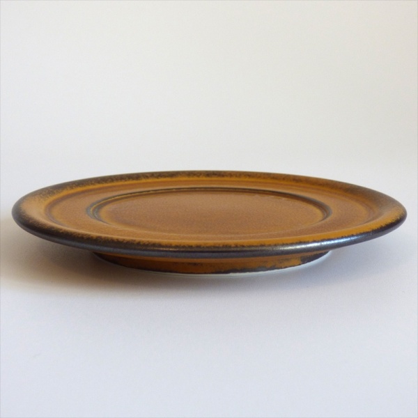 Caramel coloured saucer in profile