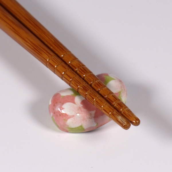 Hashi chopsticks on small blossom pattern chopstick rest
