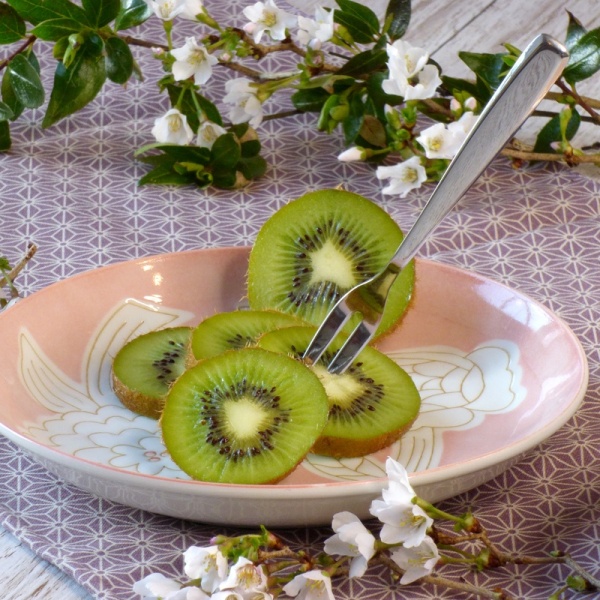 Japanese fruit fork with kiwi fruit on a plate