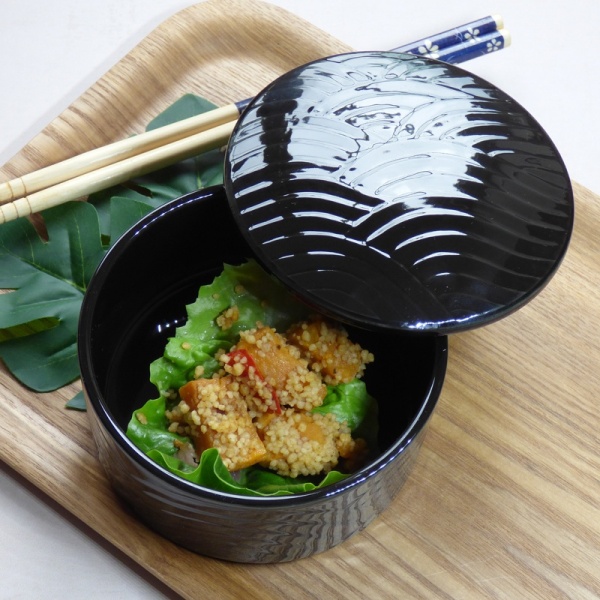 Black futamono bowl on tray with food and chopsticks