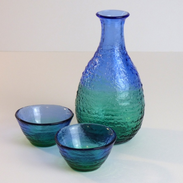 Blue green glass sake jug with two matching sake cups