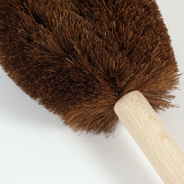 Close up of Tawashi washing up brush showing palm bristles and wooden handle