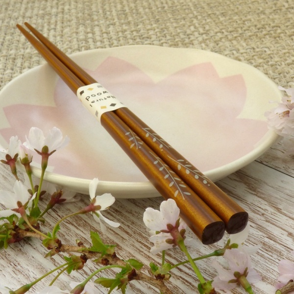 liLight oak tone natural wood Japanese chopsticks on pink Sakura plate