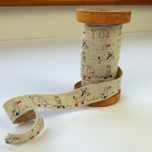 Toys linen tape on wooden reel