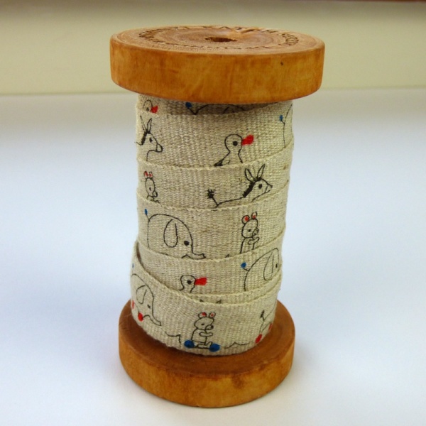Toys linen tape on wooden reel
