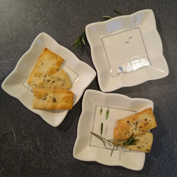 Three square mini plates with food servings