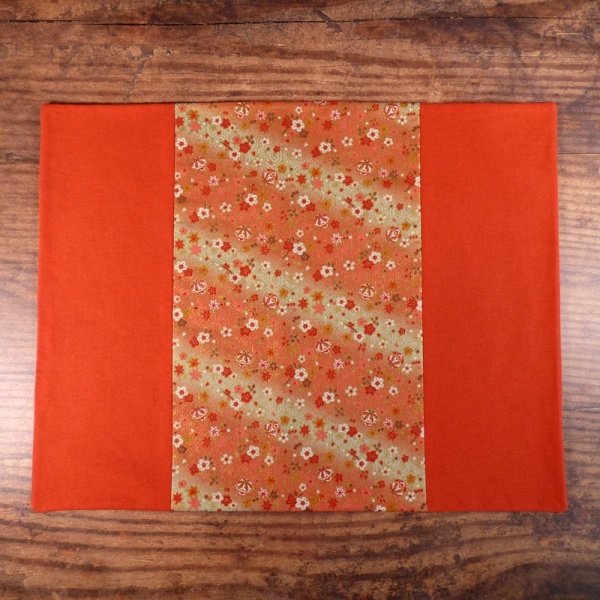 Orange Flowers & Bells placemat on table