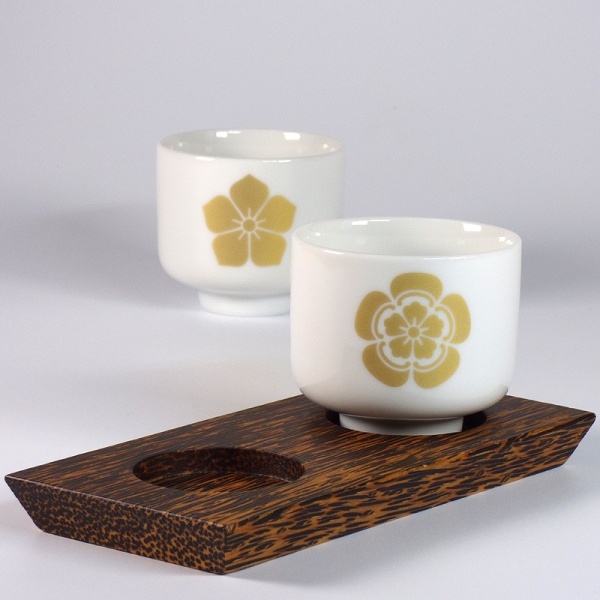 Sake cup set on coconut wood display stand