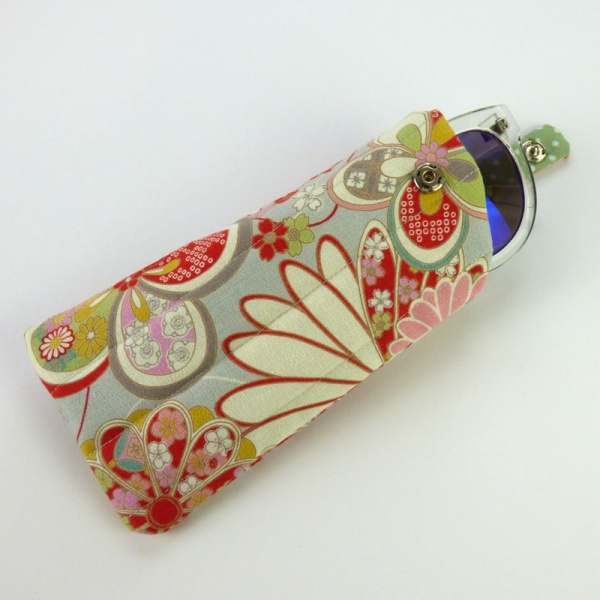Sunglasses case in pale grey traditional Japanese floral fabric with sunglasses inserted