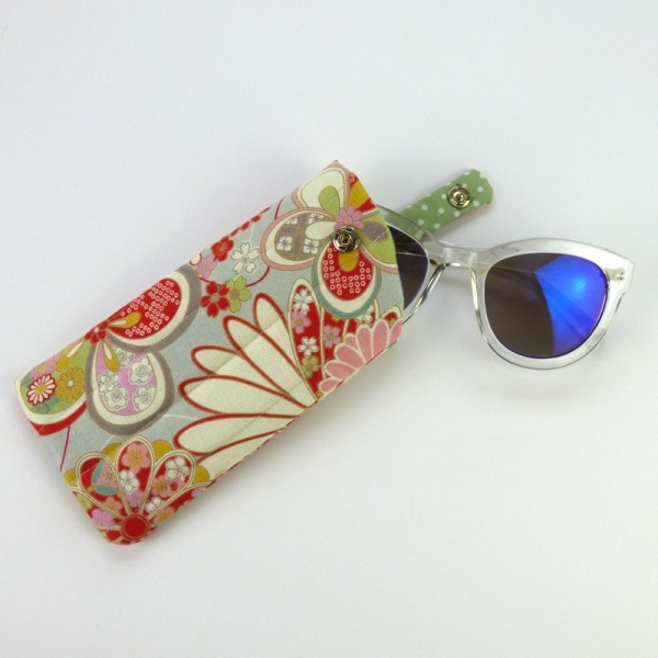 Sunglasses case in pale grey traditional Japanese floral fabric with sunglasses inserted