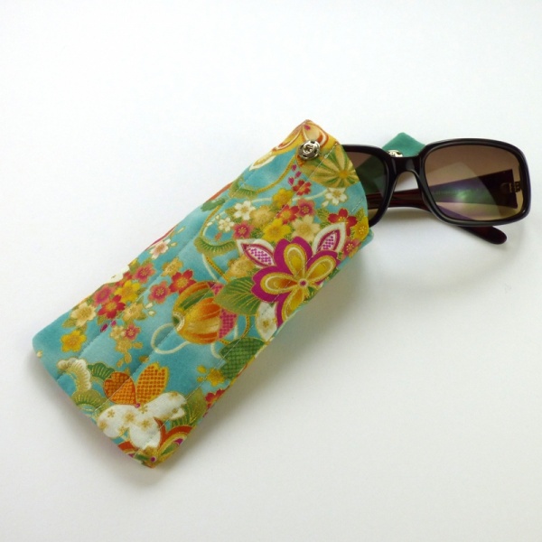 Sunglasses case in turquoise blue traditional Japanese fabric with sunglasses inserted