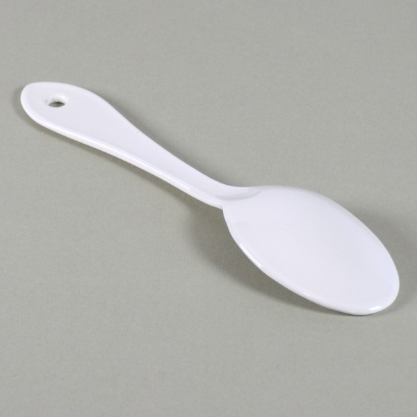White enamel sugar spoon face down