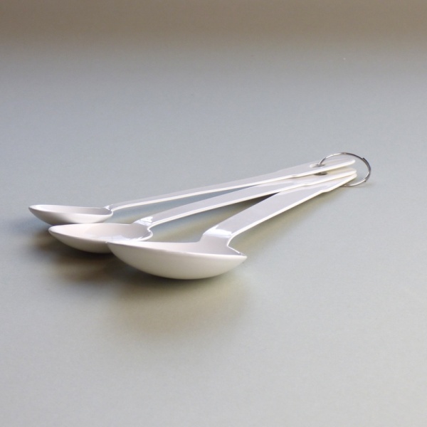 Set of three white enamel measuring spoons