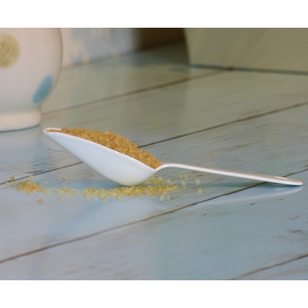 White enamel measuring mini scoop on kitchen surface