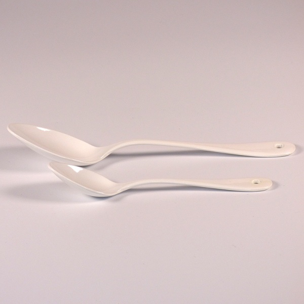 White enamel teaspoon with matching dessert spoon
