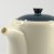 Close up of Japanese teapot's spout and dark blue lid