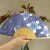 Blue hydrangea Japanese fan held in hand