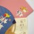 Close up of cute creature details on Japanese fan, envelope and notelet