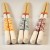 Three sets of long Japanese cooking chopsticks in yellow, turquoise and pink designs