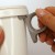 Hand showing how to attach grey mug handle