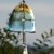 Japanese moonlight wind chime hanging in low light garden