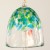 Close up of dappled green and blue design on glass wind chime