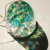 Light shining through glass wind chime creating coloured reflections