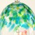 Close up of dappled green and blue design on glass wind chime