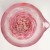 Top down view of pink swirling coloured glass design