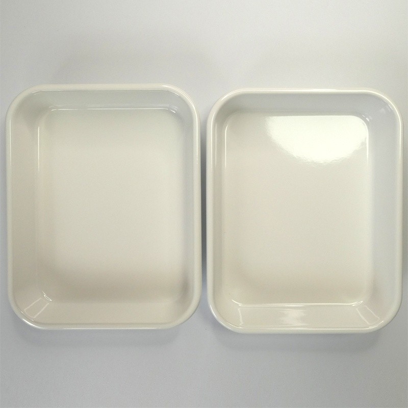 Two white enamel cooking trays