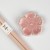 Pastel pink chopsticks with matching pink flower shaped chopstick rest