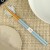 Pastel pale blue chopsticks and chopstick rest on minimalist table setting